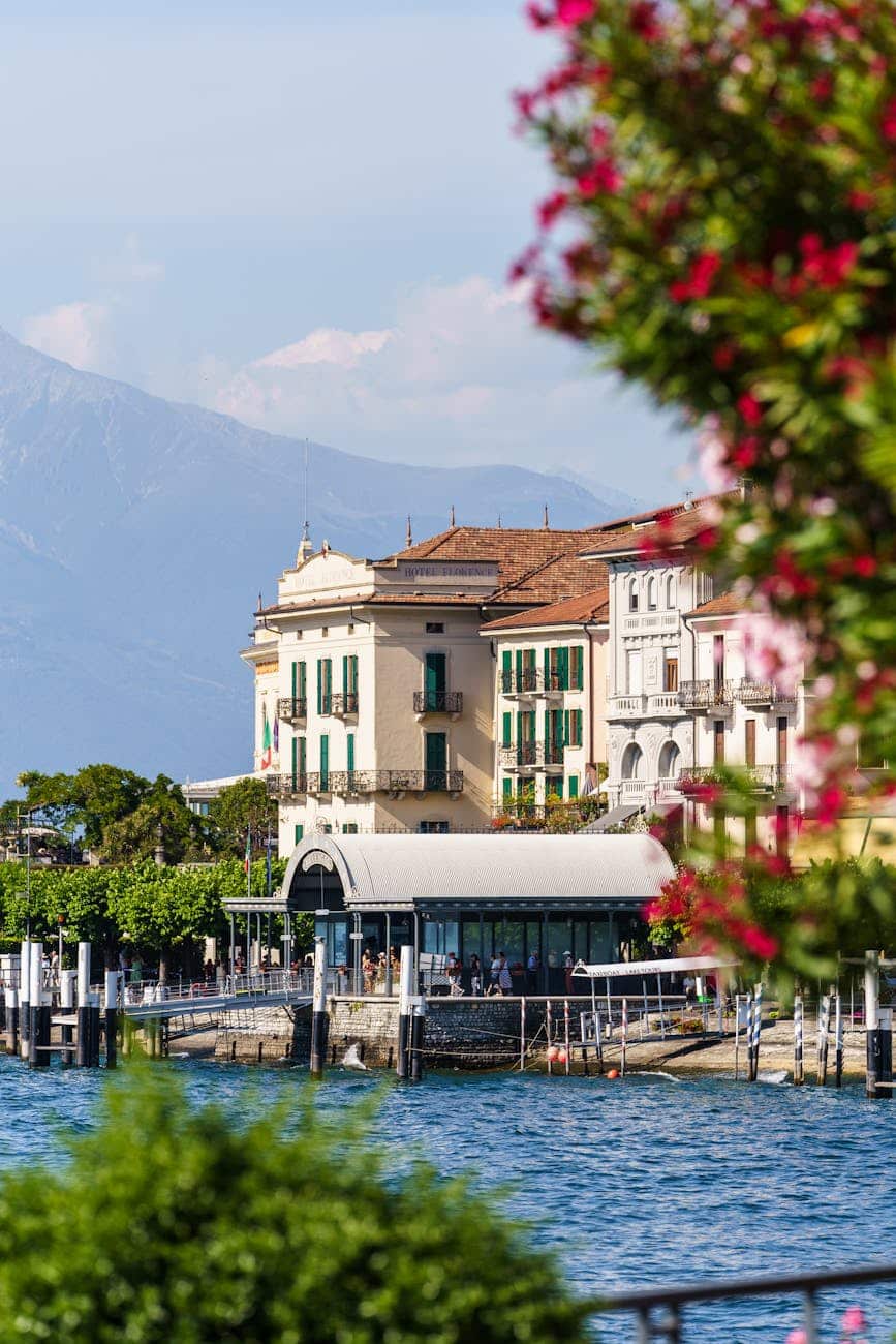 Bellagio ferry terminal view from Lake Como - Photo by Alari Tammsalu on Pexels.com, a view of the lake with buildings and mountains in the background