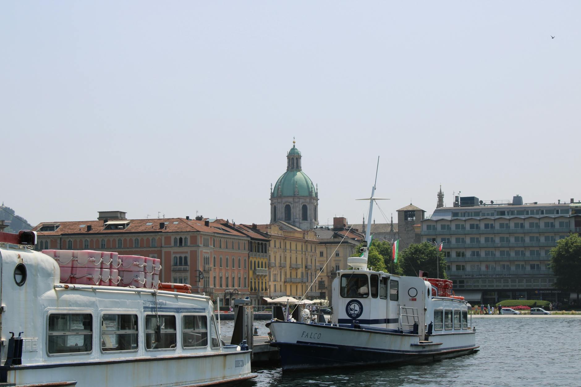 scenic view of lake como with dome and boats